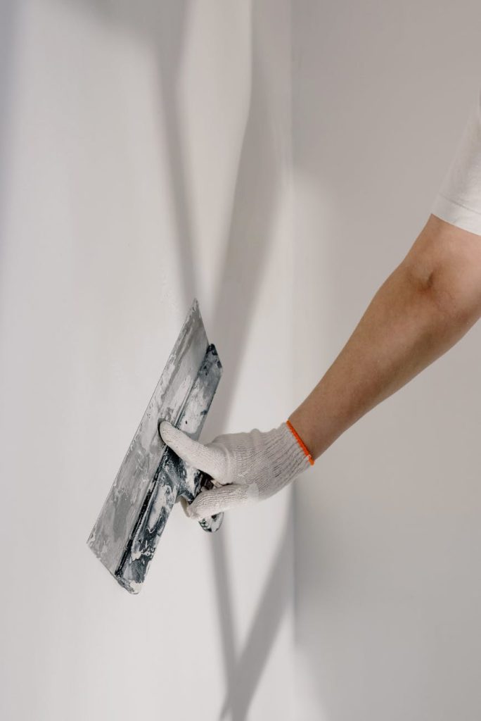 crop man preparing wall for painting